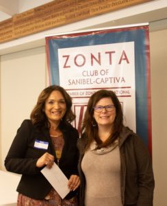 F.I.S.H. Social Services Director Nitza Lopez (L) receiving her 2020 grant award last January from Zontian Kelly Turnage 